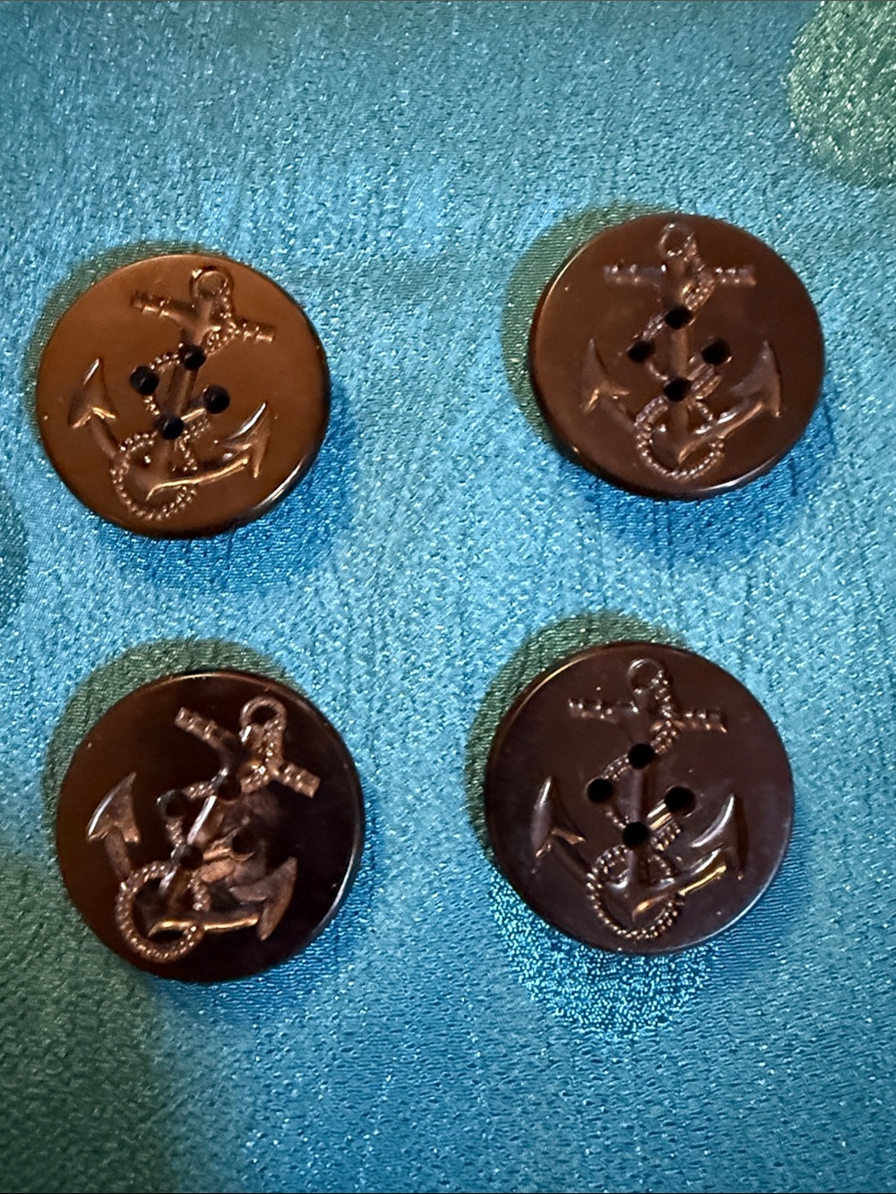 Vintage dark plastic U.S. Navy peacoat button featuring a fouled anchor